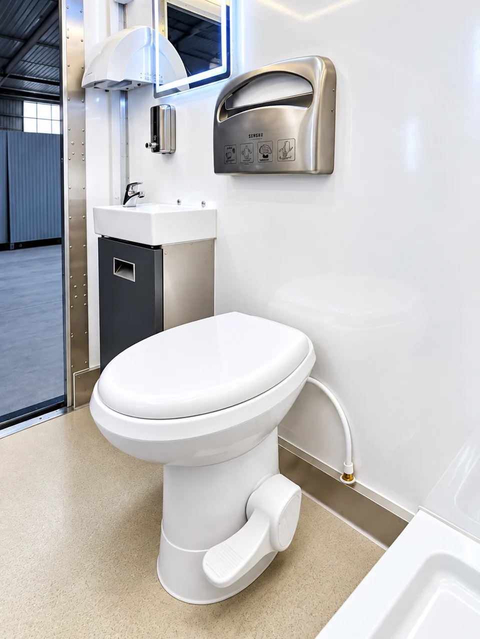 Restroom trailer interior reference with toilet and wash area from the restroom-only set