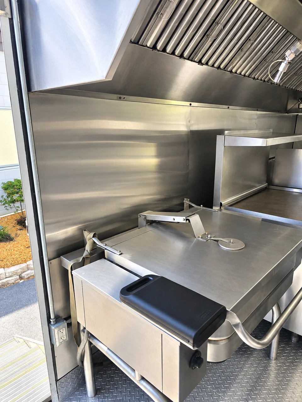 Stainless sink and preparation counter inside the 26 ft bulk mobile-kitchen reference